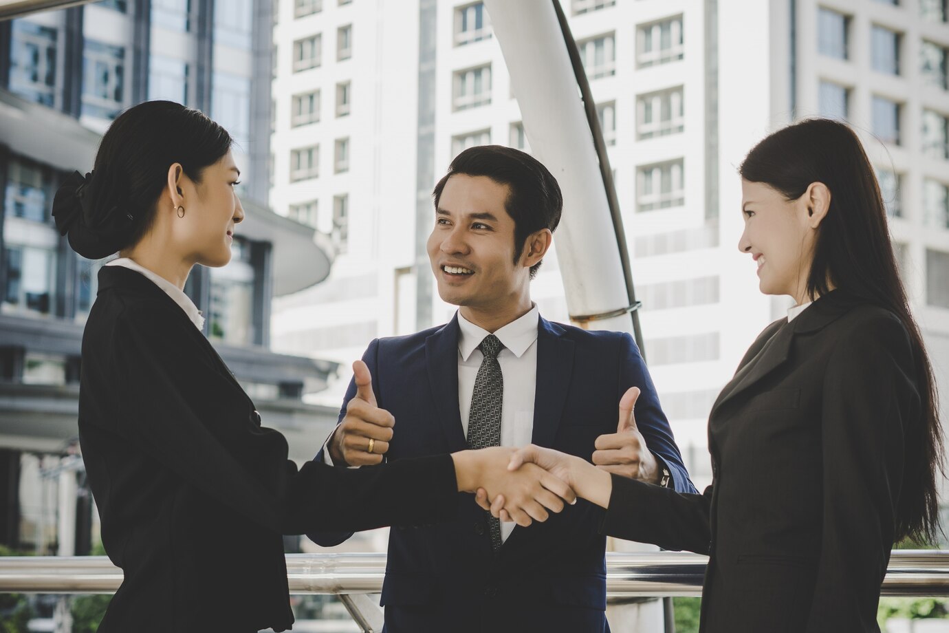 Business people shaking hands, finishing up meeting deals. Business concept.