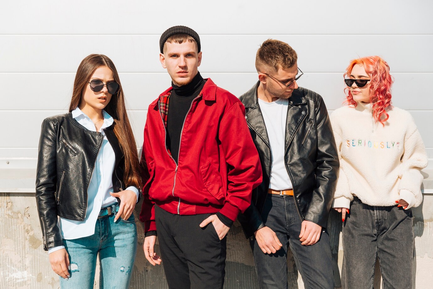 Young people in trendy wear posing on street
