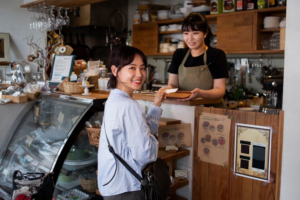 Young women arranging their cake shop