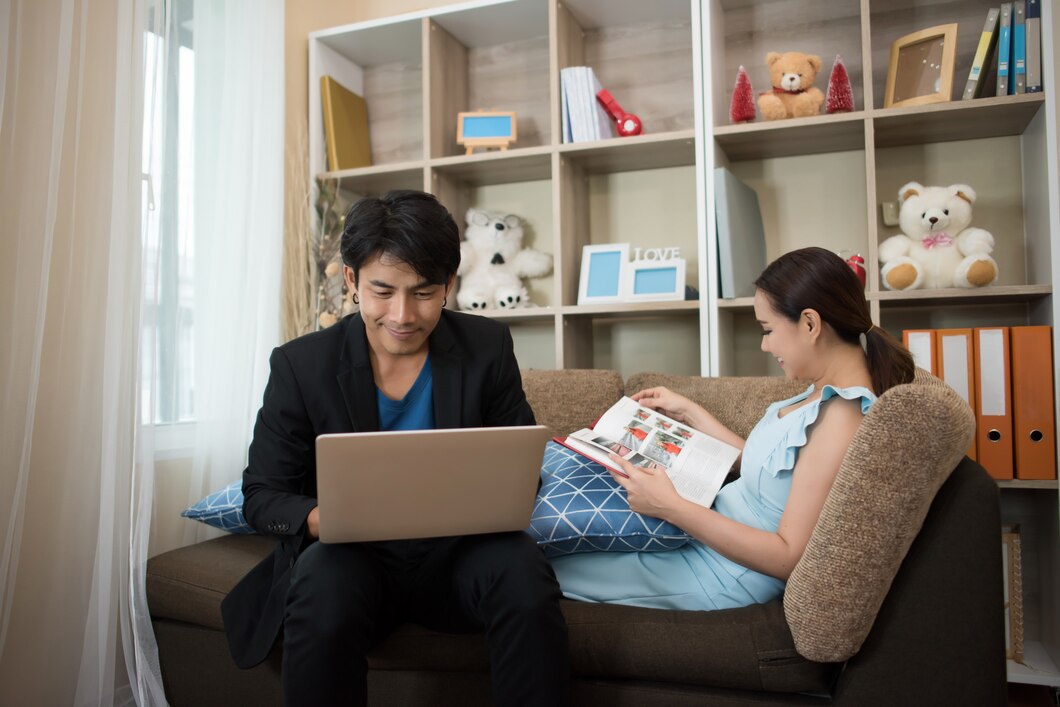 Cheerful Happy couple relaxing in sofa at home
