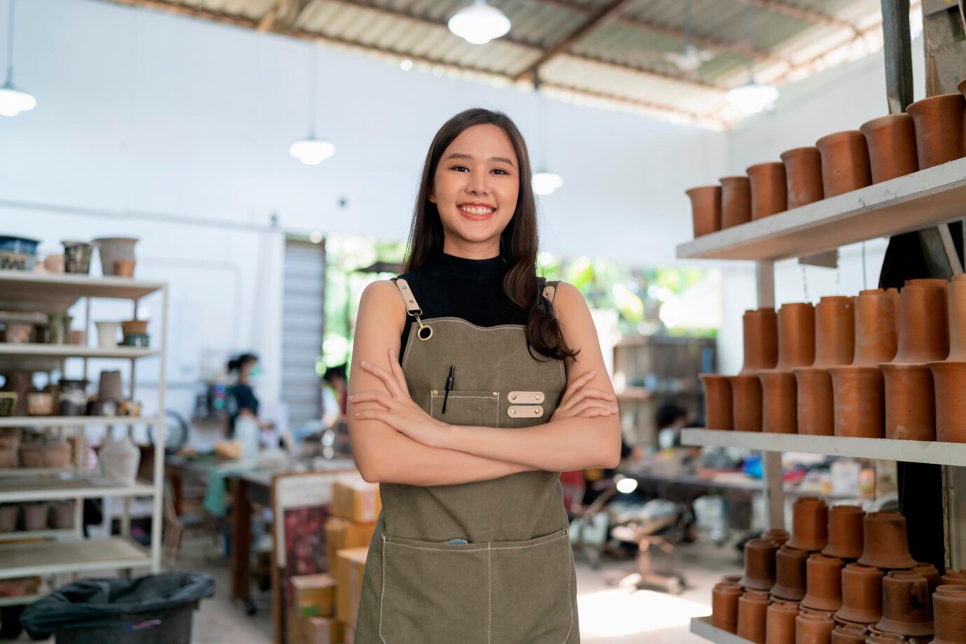 Asia female ceramist with apron hand confident chest