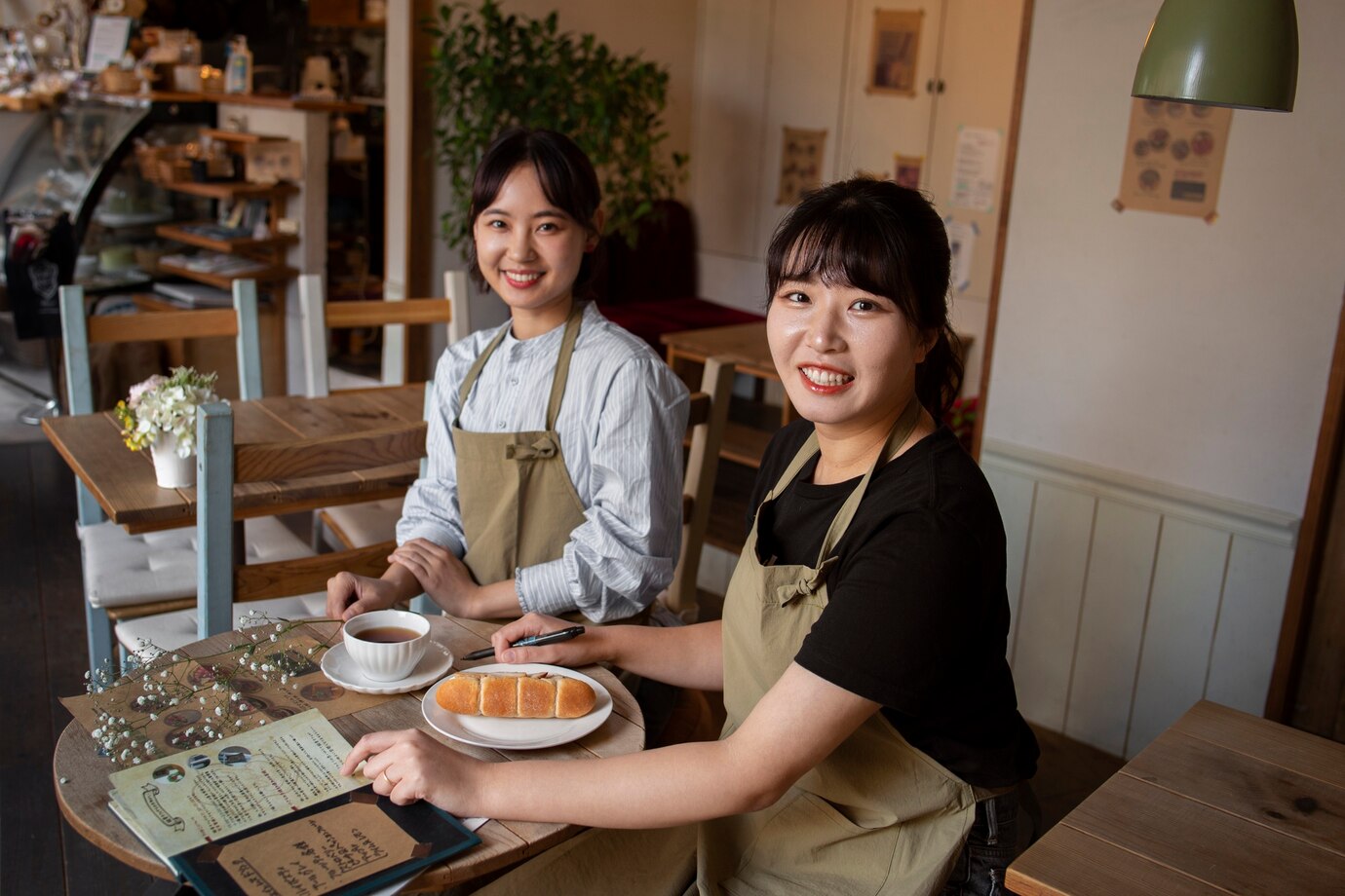 Young women arranging their cake shop