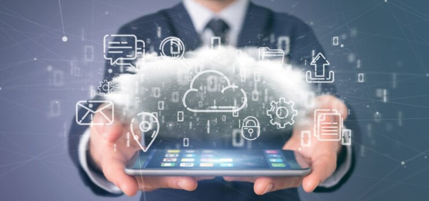 Businessman holding a cloud of multimedia icon