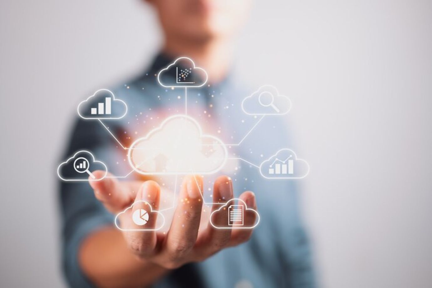 Businessman holding clouds big data analytics and business intelligence