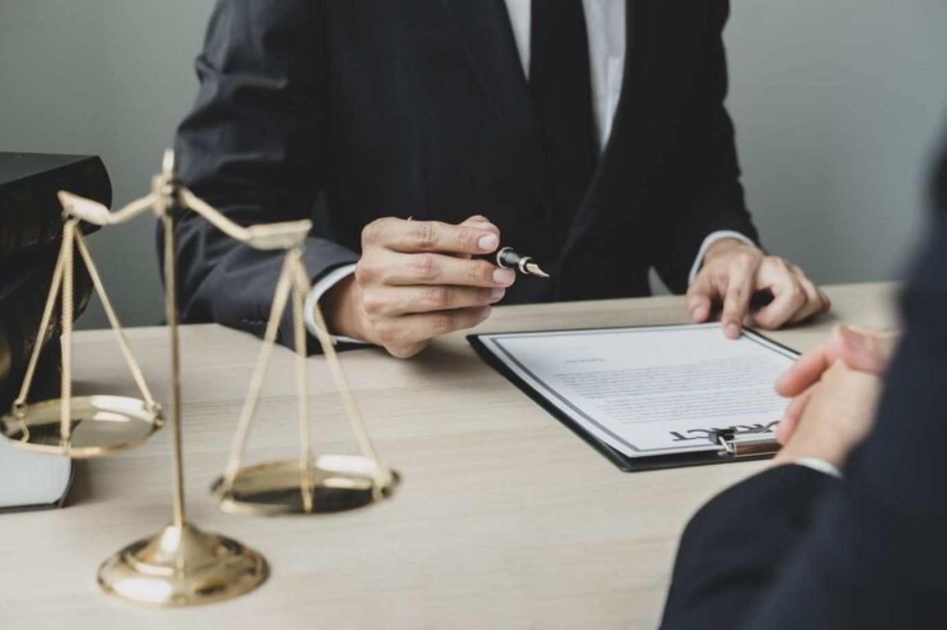Midsection of couple holding while sitting on table 