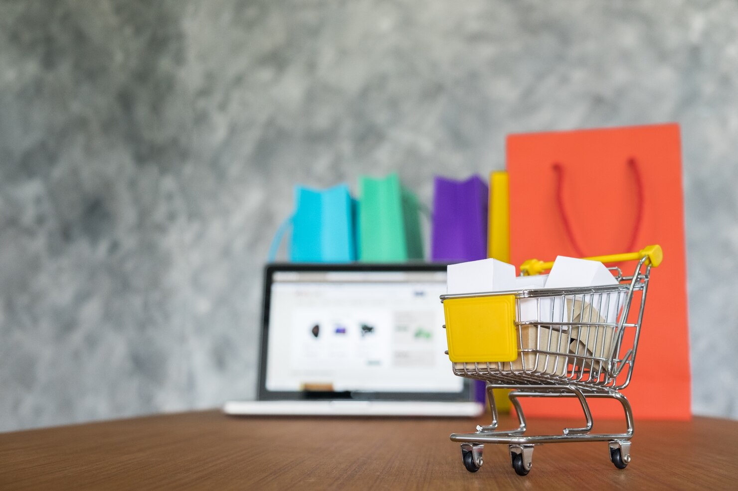Laptop and shopping bags, online shopping concept