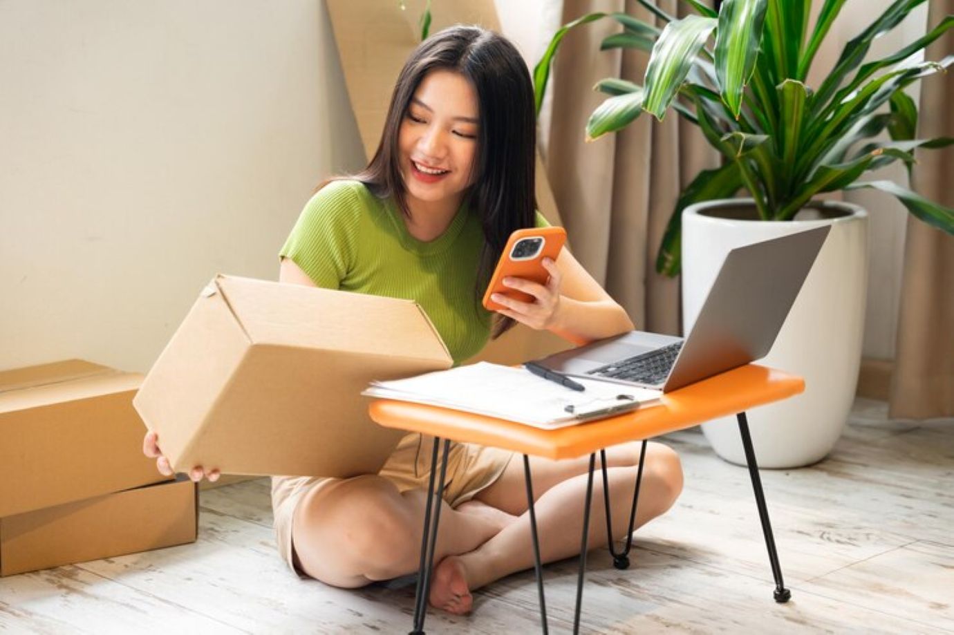 Portrait of asian woman selling online at home