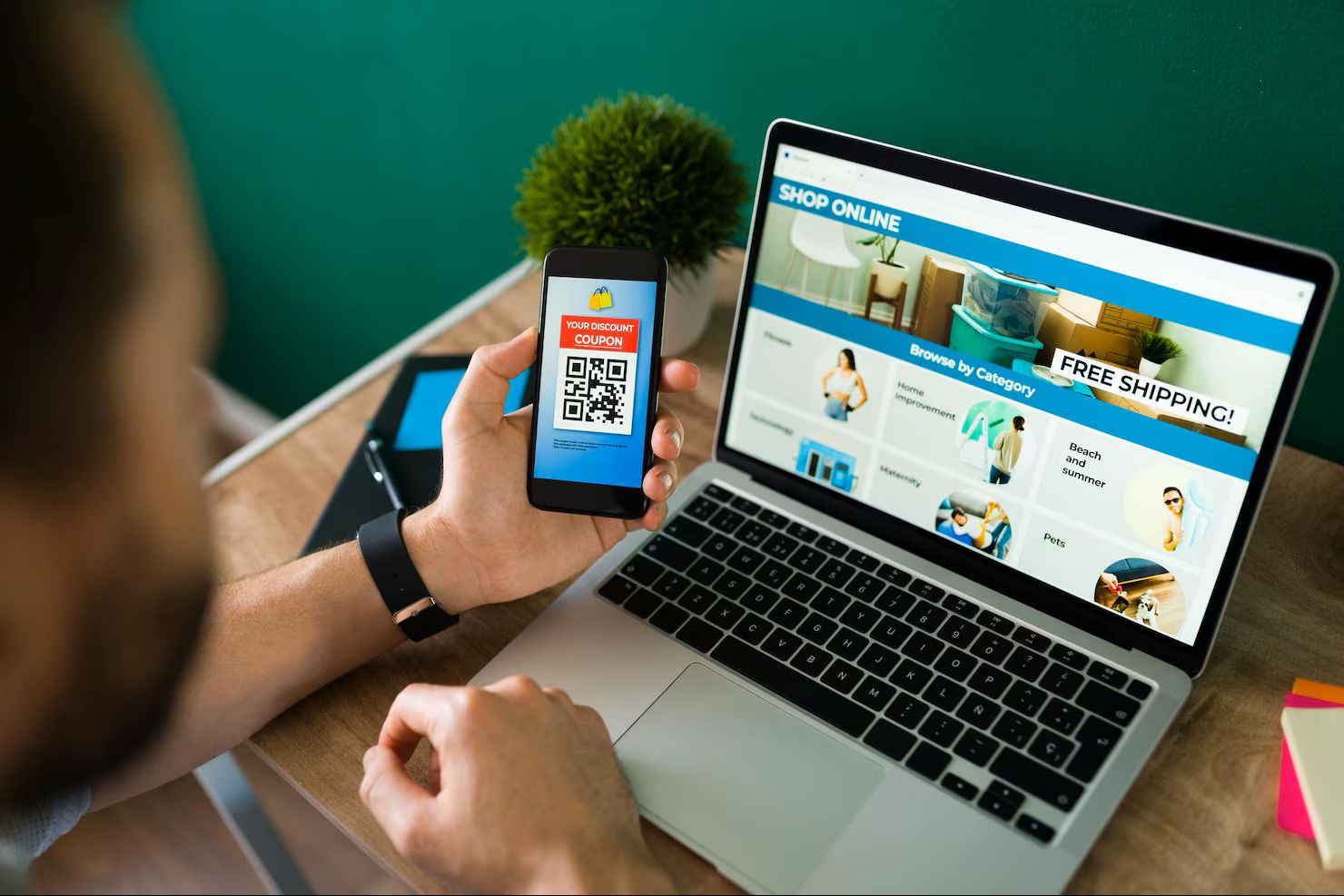 Young man using a discount coupon on his smartphone to do some online